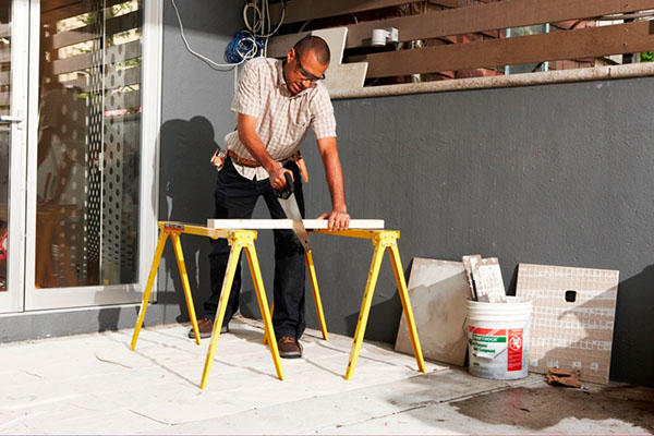 Handyman sawing a board