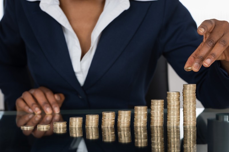 Businesswoman stacking coins