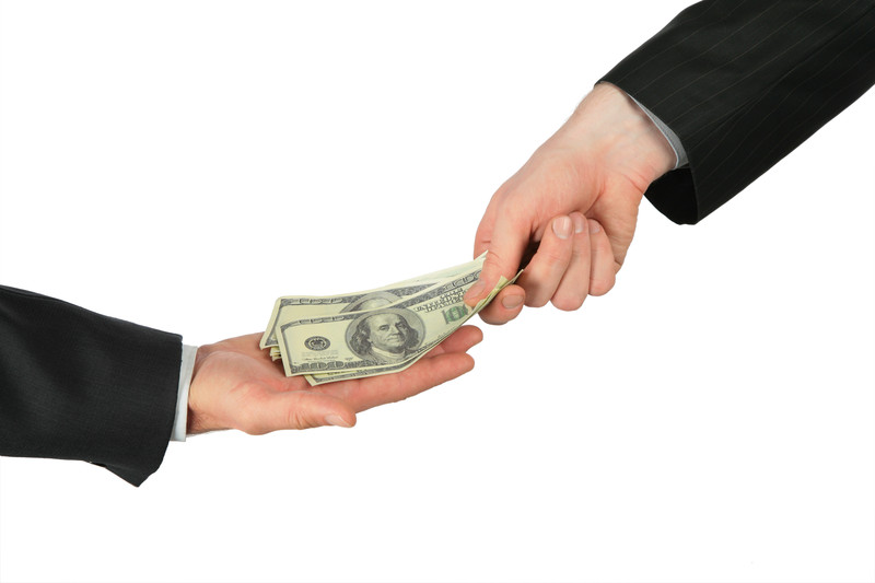 Two hands exchanging money