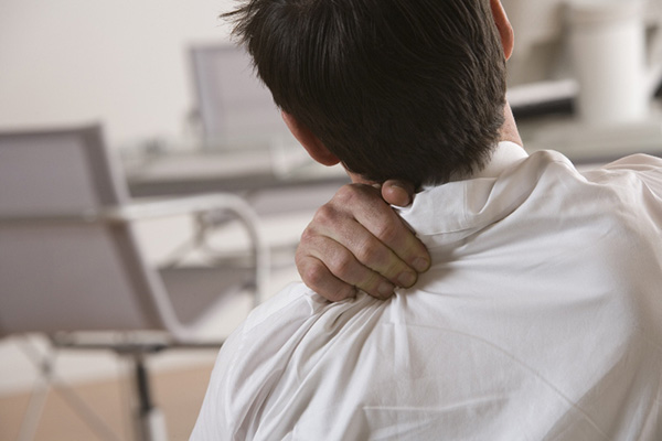 Man rubbing his sore back