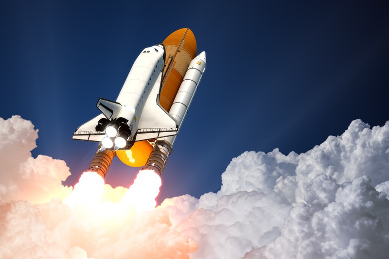 Space shuttle flying through the clouds