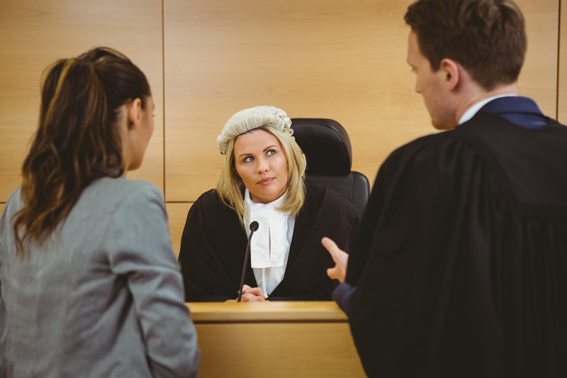 Judge talking with lawyers in courtroom