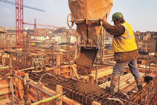 Construction worker pouring concrete