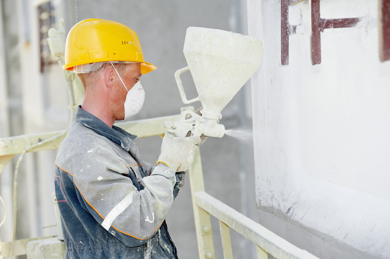 Construction worker using spray paint