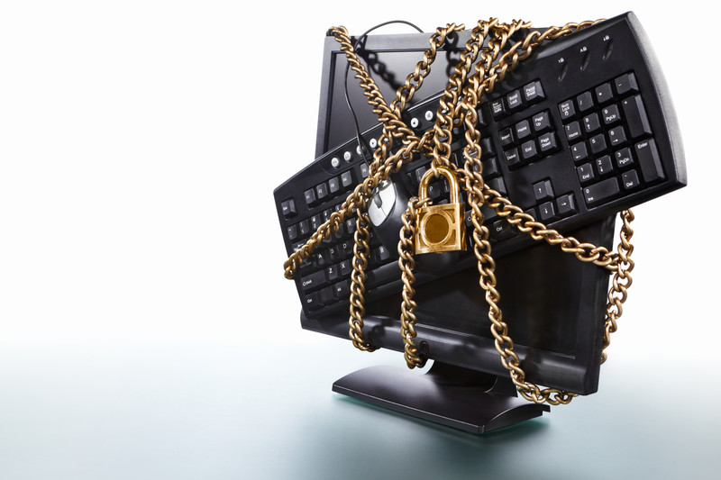 A computer monitor with chains and a padlock on it