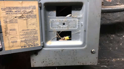 Exposed electrical panel with dust and rust 