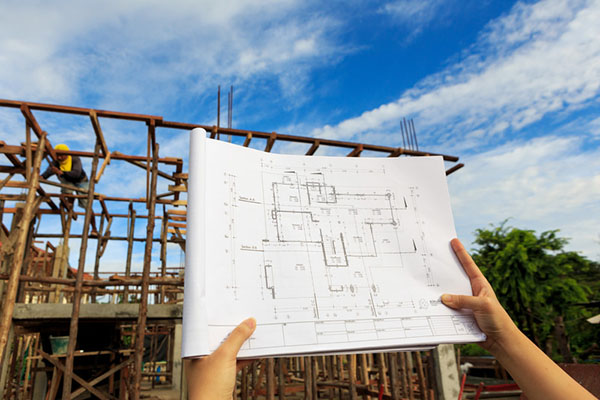 Architecture plans in front of construction