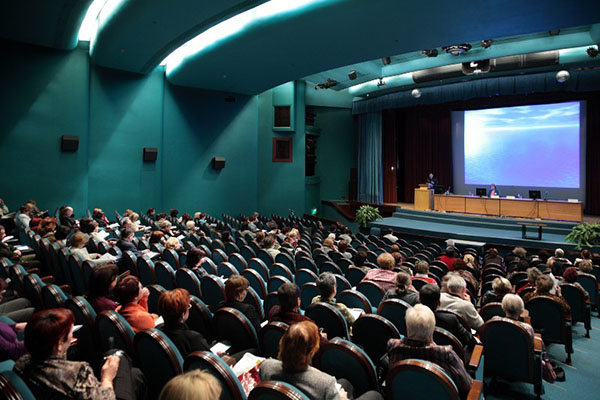 Conference-people listening to a presentation--presenter
