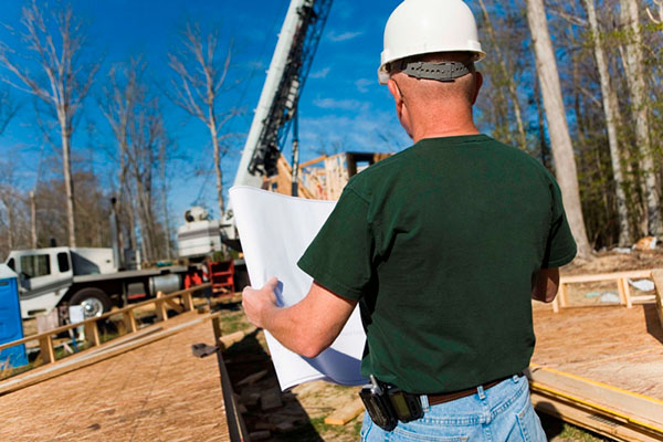 Construction worker looking at plans