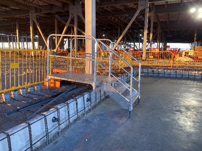 handrails on metal stairs to work areas