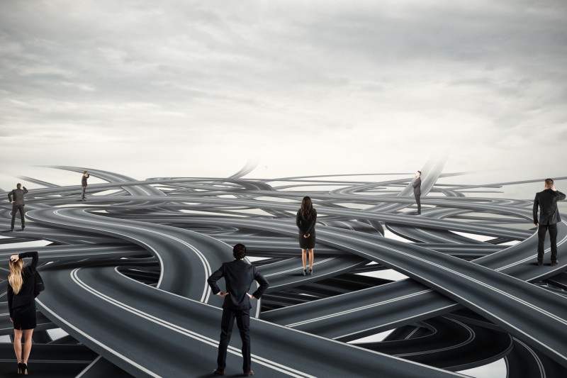 Businesspeople on a tangle of winding roads