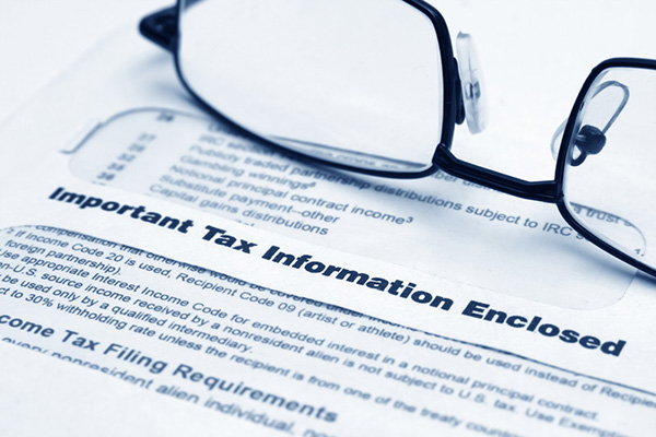 Important tax information form with glass on it