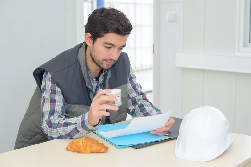 Construction worker reading mail