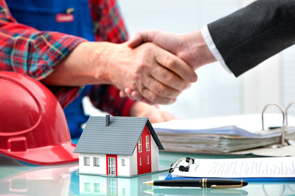 Hands shaking over construction contract deal