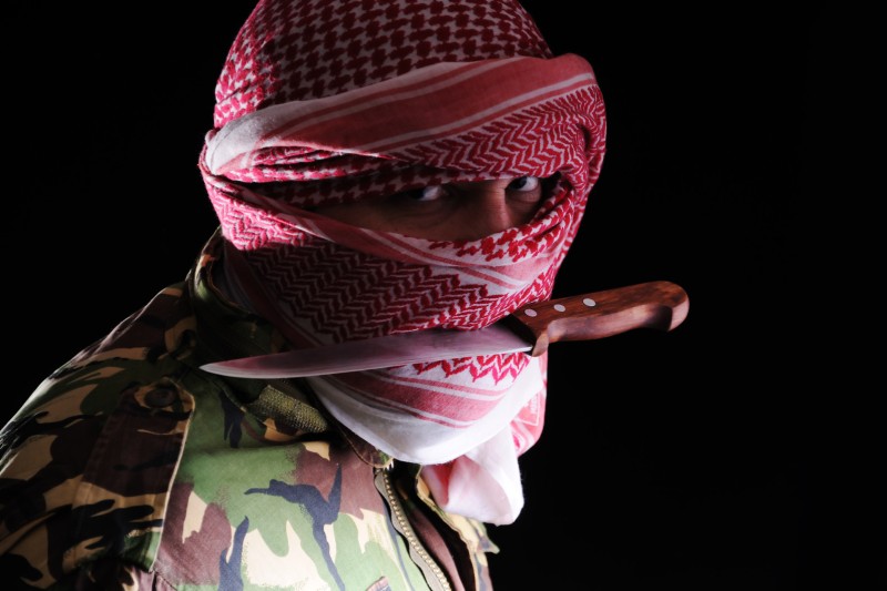Terrorist with a knife in his mouth
