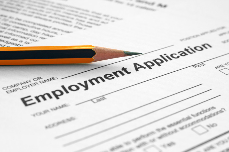 Employment application with a pencil on top of it