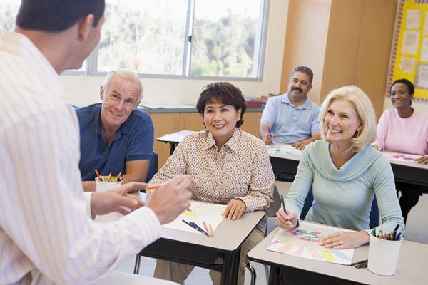Parents in a students classroom talking to a teacher