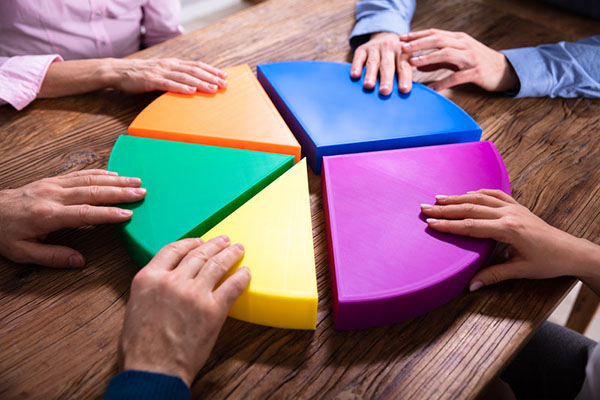 Businesspeople connecting pie chart