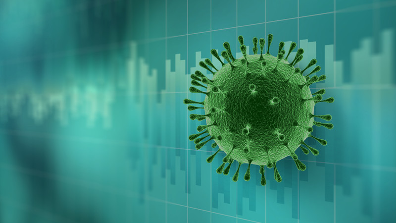 Coronavirus model in front of a graph