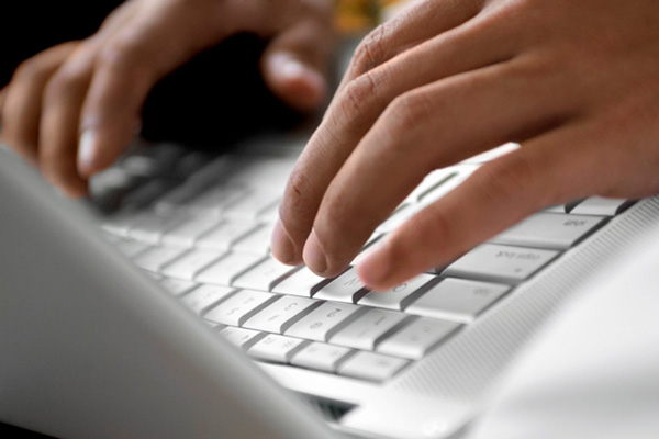 Fingers typing on a keyboard