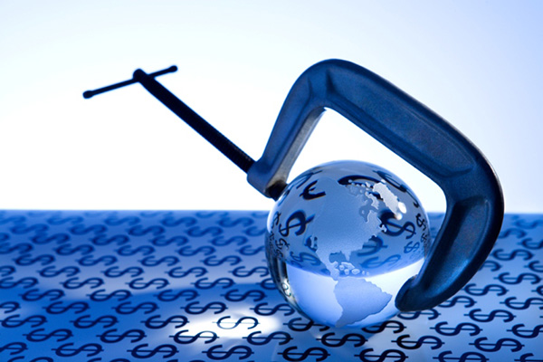 Globe in a vise on top of dollar signs