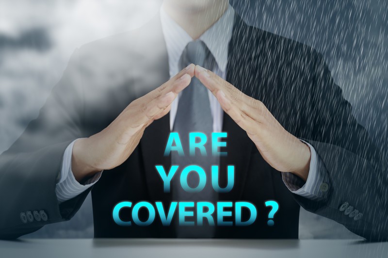 Businessman protecting the words are you covered with hands from smoke and rain