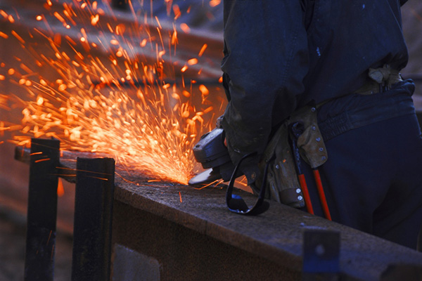 Worker cutting steel