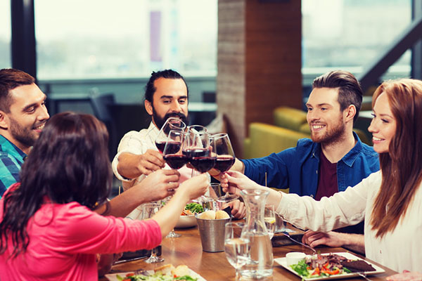 Friends dining and drinking wine