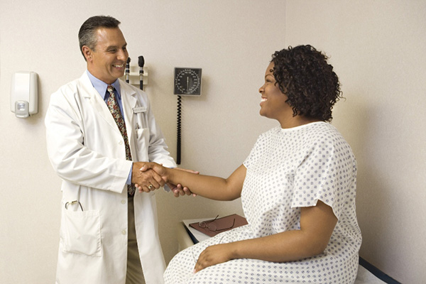 Smiling doctor with a patient