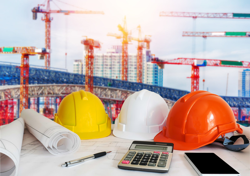 Construction site blueprints hard hats