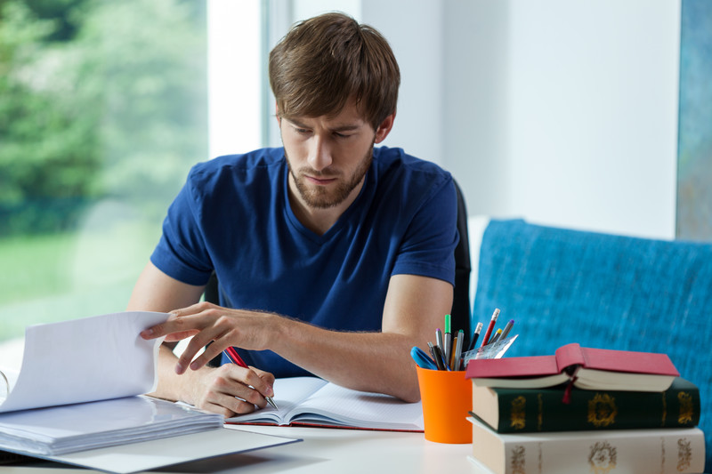College student studying by a window