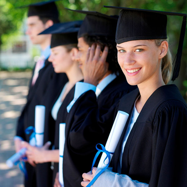 A line of graduates holding their diplomas and a close-up on one smiling graduate