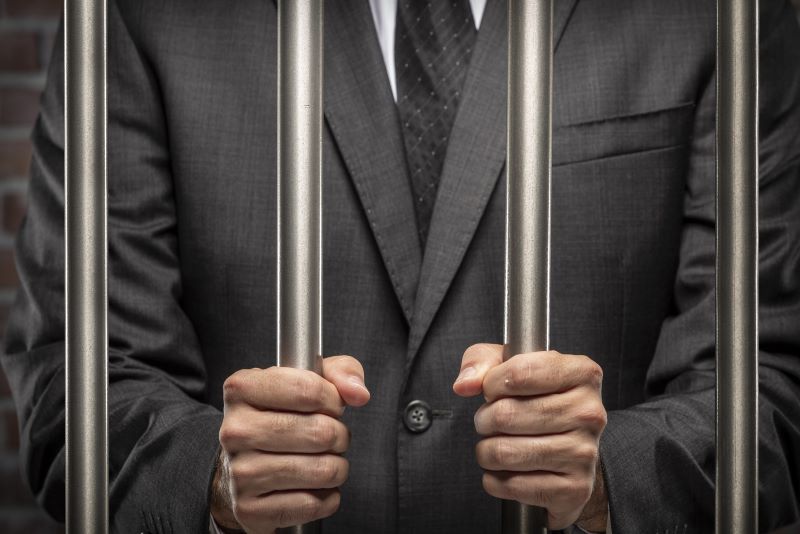 Businessperson behind bars