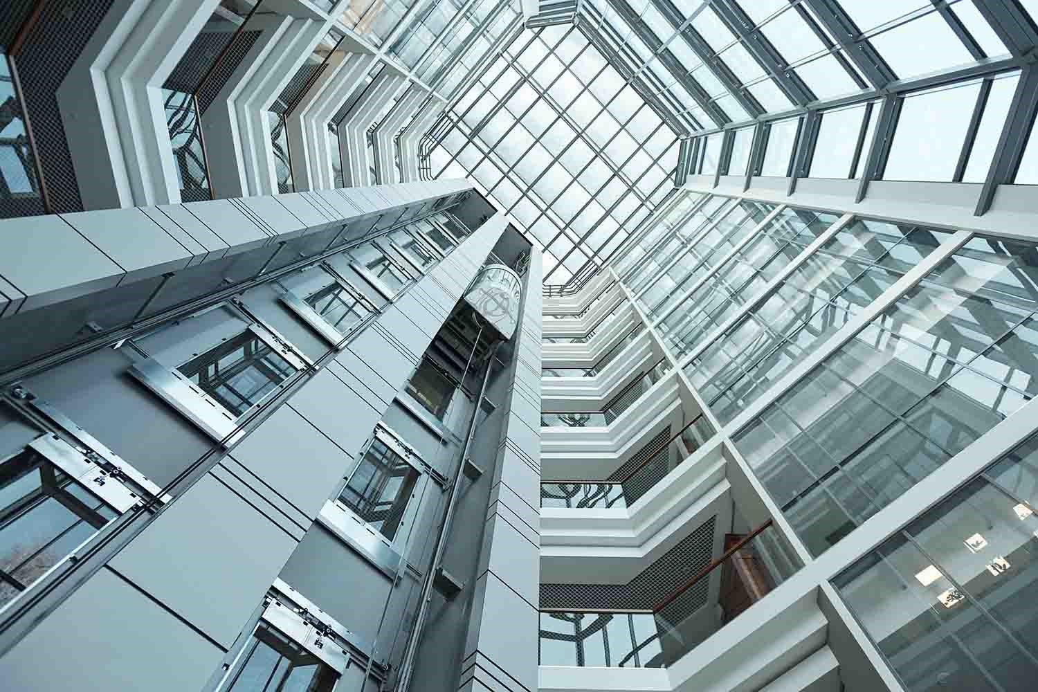 interior of contemporary tall office building with moving elevator