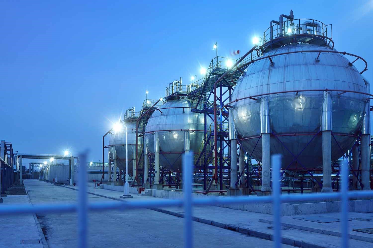 Row of Fuel Storage Tanks Lit Up At Night at a Chemical Plant
