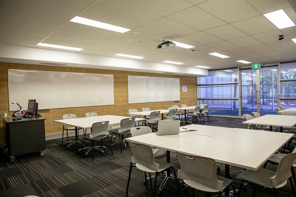 Empty Classroom for Professional Education with Projector and Shared Desks