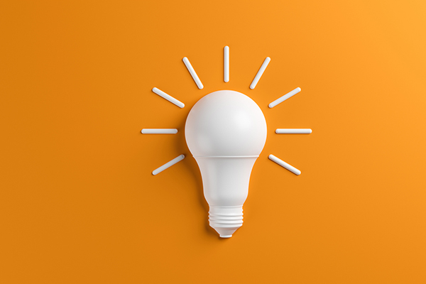 white lightbulb on orange background
