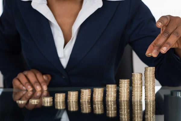 businesswoman stacking coins
