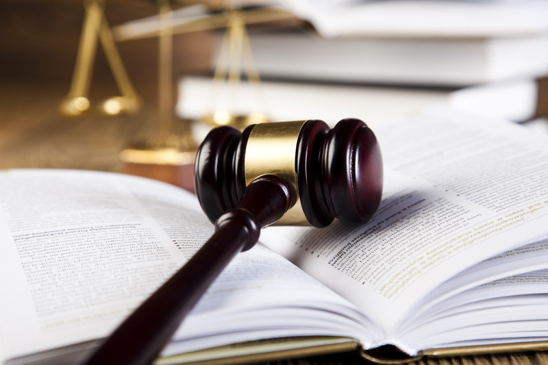 Gavel on book with scales