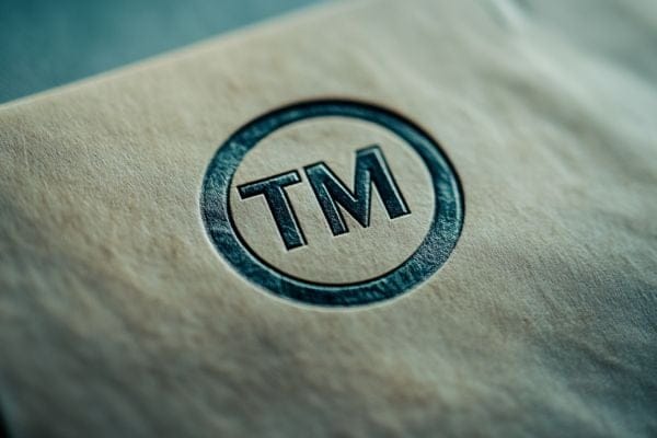 stamped envelope with the letters TM circled