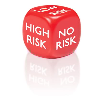 A rid die that says low risk, no risk, and high risk on each side