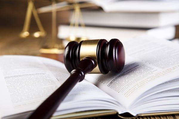 Gavel on book with scales