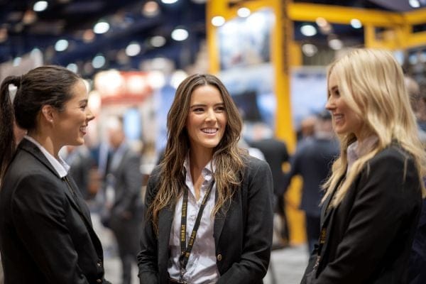 Three professional women at a construction networking event