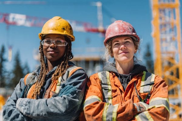two smiling women construction workers on a construction site