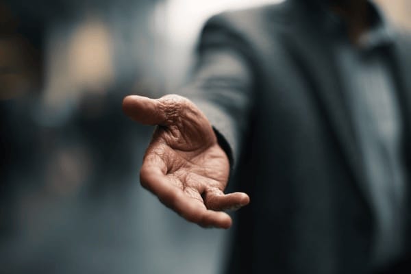 A businessman with his hand outstretched and palm up