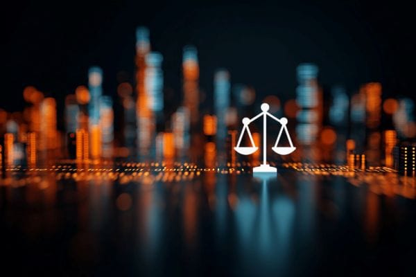 white legal scales icon in front of a blurred binary New York City skyline