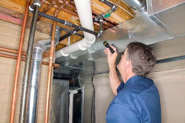 Man inspecting pipes