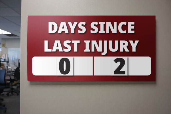 Sign on the wall of a business that reads "Days Since Last Injury" with a 0 and a 2 hanging below it