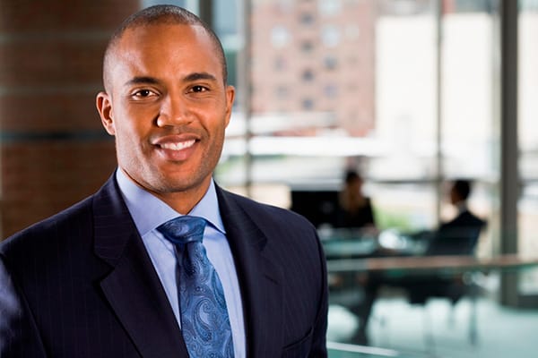 Businessman with coworkers in background