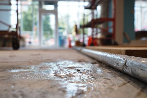 Water next to a leaky pipe on a construction site